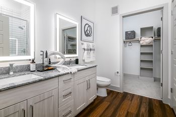 A bathroom with a white toilet and a white sink.